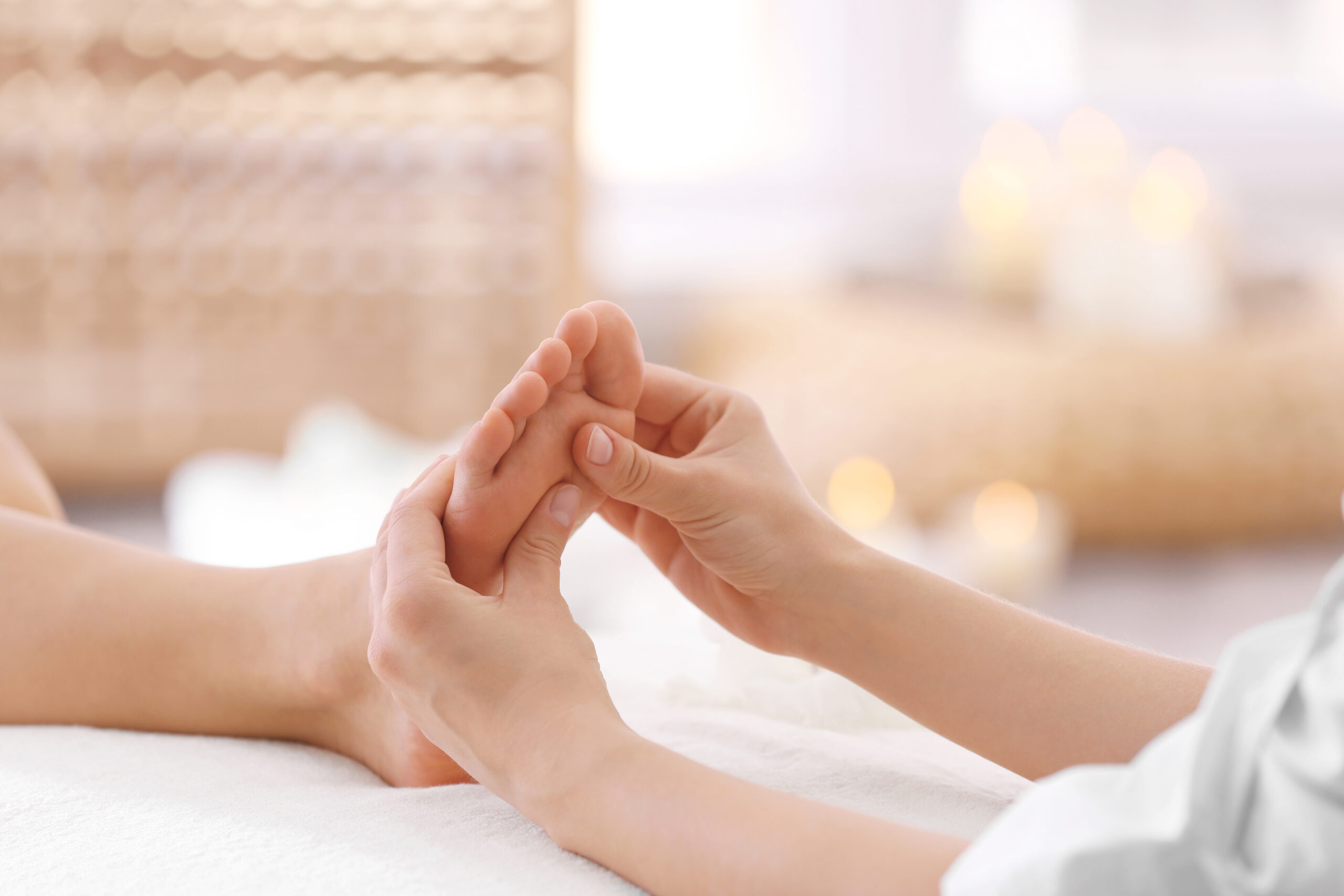 Foot massage in spa salon, closeup